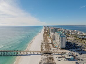 A coastal area with a beach, a pier, and high-rise buildings. - Walk to Navarre Beach - Stylish Coastal Retreat w/ Beach Gear + Pet Friendly (Navarre)