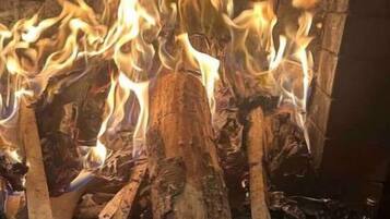 Cozy up by the fireplace with a roaring fire.