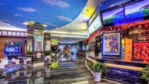 A spacious lobby with a polished marble floor, a reception desk, and a large digital screen displaying content. - Tongren Jinjiang Hotel (Tongren)