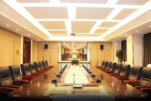 A conference room with a long table, chairs, and a projector screen. - Tongren Jinjiang Hotel (Tongren)