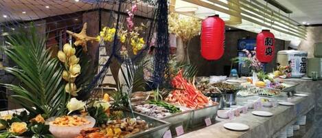 A buffet with various food items and decorative elements.