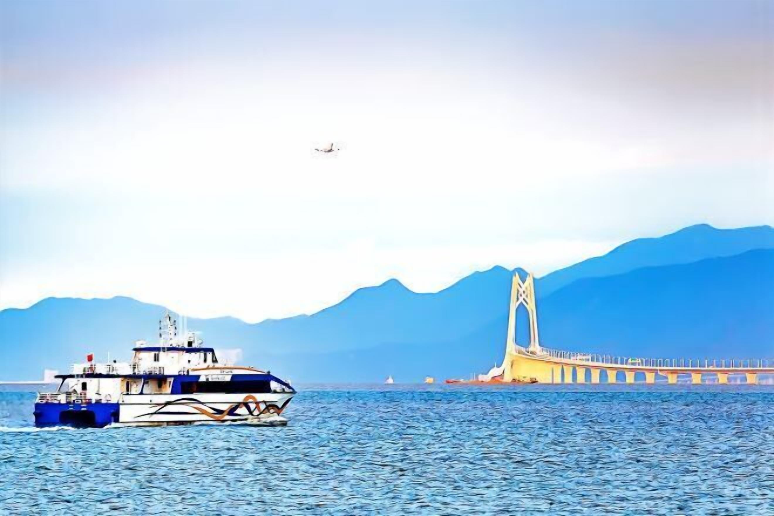 A ferry boat on a body of water with a bridge in the background.