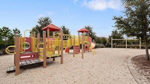A playground with a slide and climbing structures.