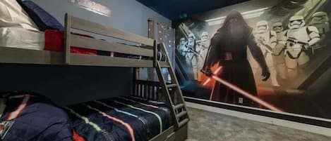 A bunk bed with a Star Wars-themed wall mural.