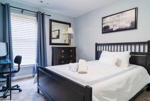 Relax in a stylishly designed room with a comfortable bed, desk, and large window.