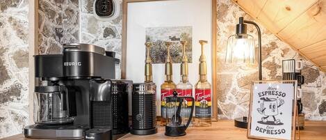 A coffee station with various brewing equipment, espresso machines, and coffee beans.