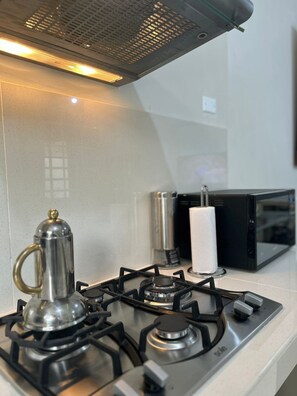 Fridge, microwave, coffee/tea maker, cookware/dishes/utensils