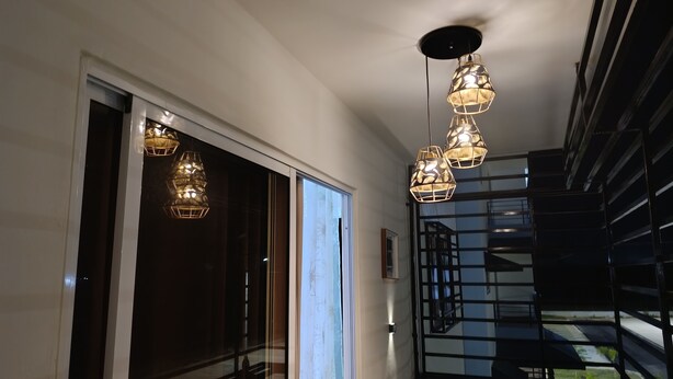 A modern interior with a staircase, pendant lights, and a view of the outdoors. - A place of relaxation and disconnection (Boca Chica)