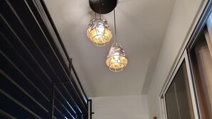 A balcony with a chair, two pendant lights, and a view of the night sky. - A place of relaxation and disconnection (Boca Chica)