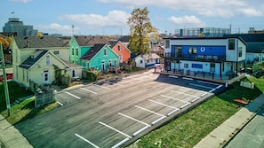 A parking lot with a row of colorful houses in the background. - Awesome Custom Built Home. Perfect Indy Location! (Indianapolis)