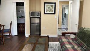 A compact living space with a kitchenette, a dining area, and a seating area. - Quiet Country 1-bedroom apartment in Royal Oaks with beautiful views (Prunedale)