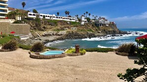 A coastal hotel with a pool, rocky cliffs, and ocean views. - PrivateJacuzzi-LasOlasCondo-Pool&Jacuzzis-Rosarito (Playas de Rosarito)
