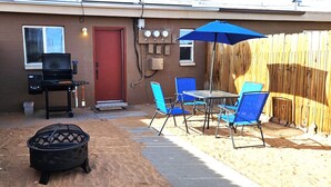 A backyard with a barbecue grill, outdoor seating, and a fire pit. - 1Bd, King, Brkfst, Large TVs, W/D, Sleeps 4, BBQ (Page)