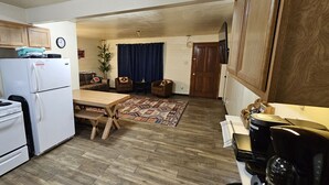 A compact kitchen with a stove, refrigerator, and wooden cabinets. - 1Bd, King, Brkfst, Large TVs, W/D, Sleeps 4, BBQ (Page)