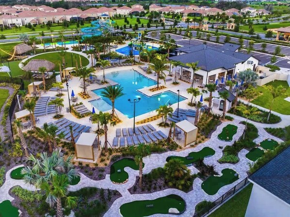A resort with a central swimming pool, multiple lounge areas, and a golf course. - Luxe Villa with Pool and Spa, Game room & Free Resort Access! Sleeps 22! (Davenport)