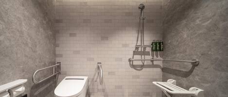 A modern bathroom with a toilet, bidet, and shower.