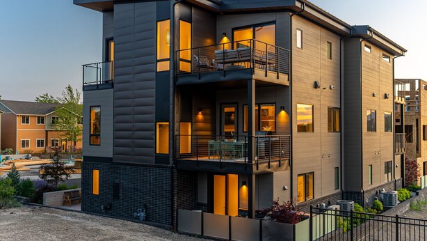 A modern multi-story building with balconies, large windows, and outdoor seating areas. - Millpointe Main 3.0 - Luxury Meets Location: Sauna, Cold Plunge, Concerts nearby (Bend)