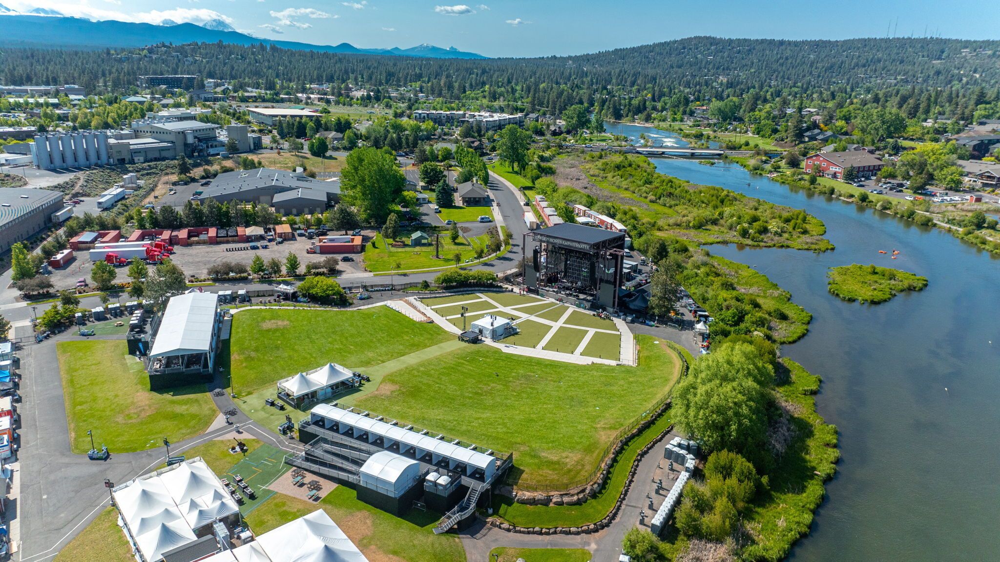 Vue aérienne d’un campus dont le bâtiment principal est entouré d’espaces verts et bordé par une rivière.