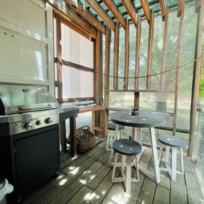Enjoy al fresco dining with a barbecue grill and seating for two.
