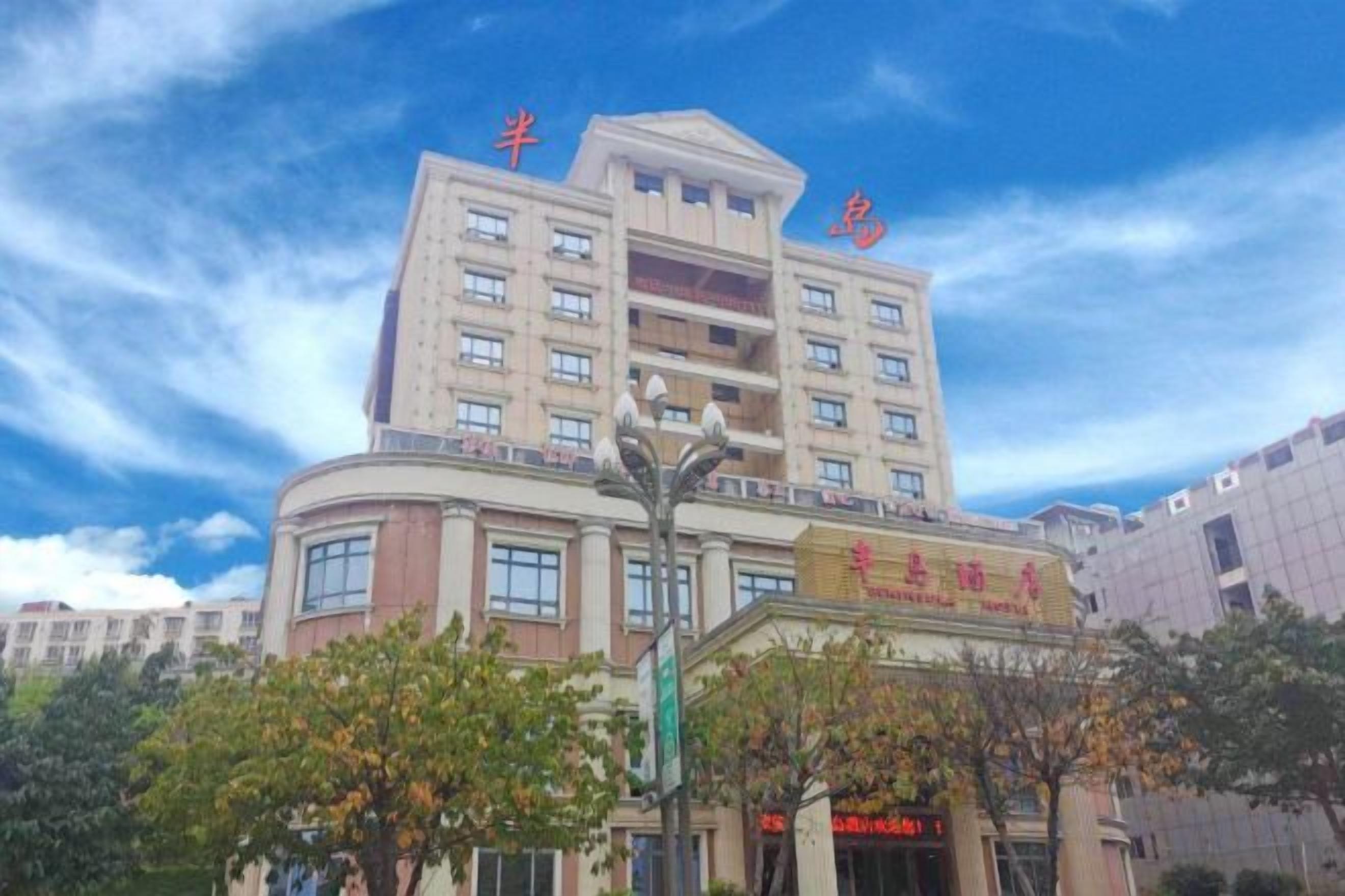 A multi-story hotel with a prominent entrance and signage.