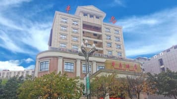 A multi-story hotel with a prominent entrance and signage.