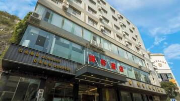 A multi-story hotel with a modern facade, large windows, and a prominent entrance.