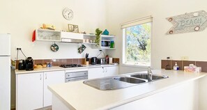 Dishwasher, coffee/tea maker, cookware/dishes/utensils, dining tables