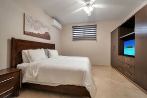 A bedroom with a bed, a nightstand, a wardrobe, a ceiling fan, and a window with blinds. - Ocean View, 2 Infinity Pools, Pedregal, 3 King bed (Cabo San Lucas)