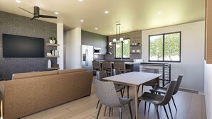 A modern kitchen with a dining area, built-in appliances, and a large window providing natural light. - Experience Elegance at the Montclair in Our Luxury Villa (Springdale)