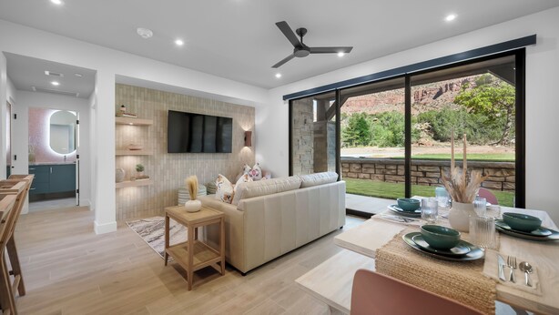 A modern kitchen with a dining area, large windows, and a view of the outdoors. - Montclair Zion - a luxurious Villa that embodies comfort and style with balcony (Springdale)