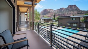 A balcony with a pool, wooden ceiling, and mountain views. - Montclair Zion - a luxurious Villa that embodies comfort and style with balcony (Springdale)
