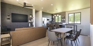 A modern kitchen with a dining area, built-in appliances, and a large window providing natural light. - This stunning 3 bed, 3 bath villa offers modern amenities and breathtaking views (Springdale)
