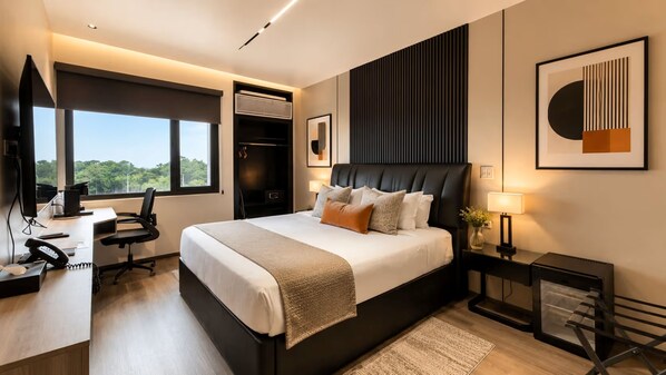A modern bedroom with a large bed, a desk, and a wardrobe. - Wyndham Garden Belize City Grand Resort (Belize City)