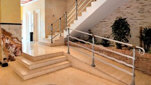 A modern staircase with a metal handrail, leading to a landing with a door. - ACV - Costa Azahar I-2nd line 3rd floor 3 north 2 (OROPESA)