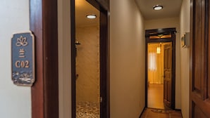 A hallway with a sign reading "C02" and a door leading to a room with a patterned floor. - Penang Story Linn House (George Town)