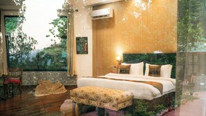 A bedroom with a large bed, bedside tables, a window, and a view of trees. - amã Stays & Trails Writer's Hill Nahan, Sirmaur Himachal (Nahan)