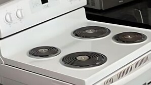 A kitchen with a white stove, a microwave, and dark wooden cabinets. - Beautiful place with Kitchen, Washing Machine, Internet near UBC, beach and DT (Vancouver)
