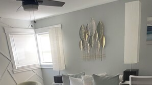 A modern bedroom with a large bed, a desk, and a chair. - Charming 3-bedroom house in Park Forest with WiFi, Large Flat Panel TVs & Google (Park Forest)
