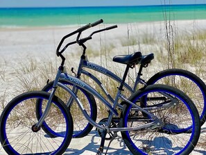 A bicycle with '30ava' branding, parked on a sandy beach with a clear blue sky and ocean in the background. - Private beach access, Gulf Views, on-site golf car (Santa Rosa Beach)