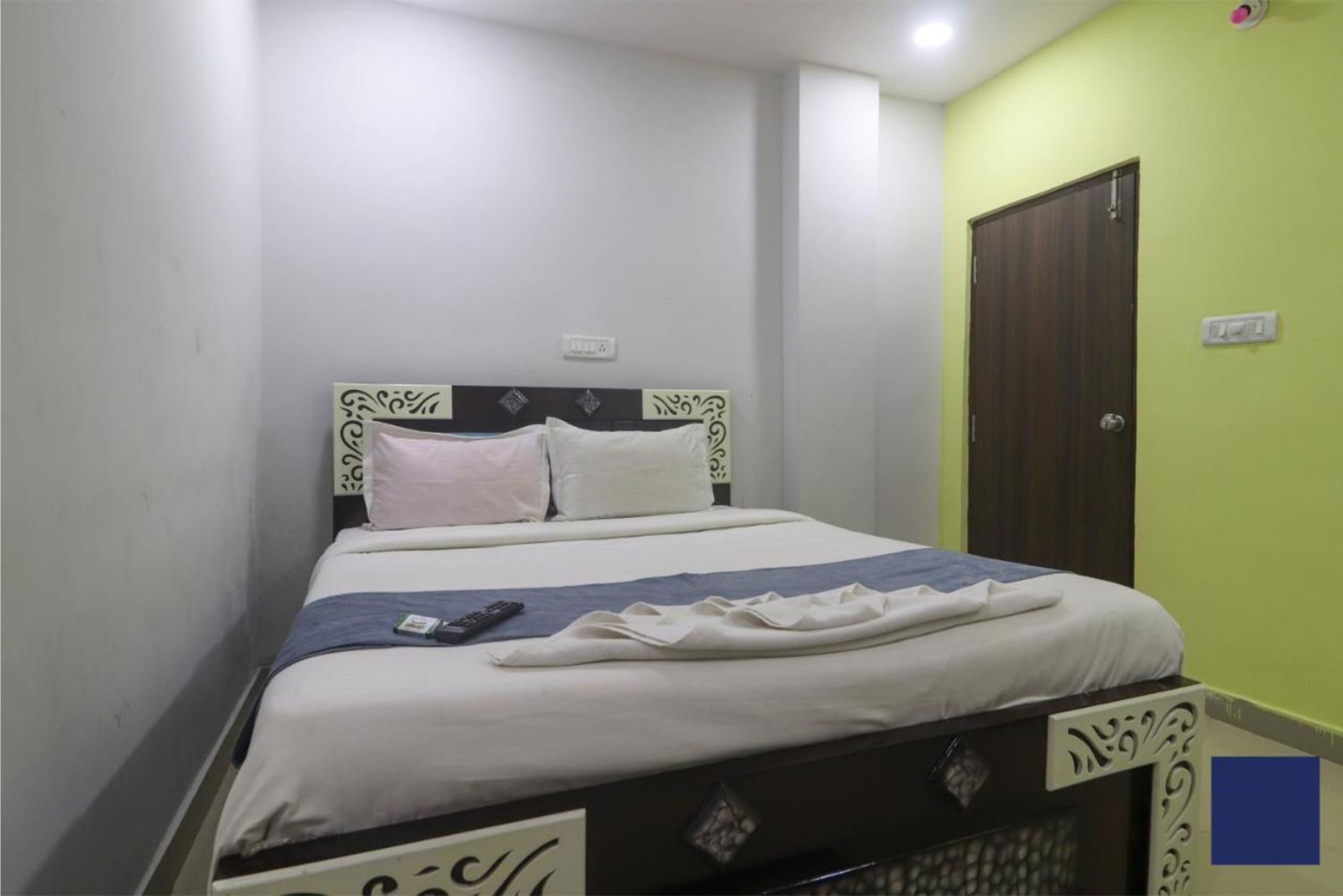 A single bed with a headboard, a bedside table, and a nightstand.