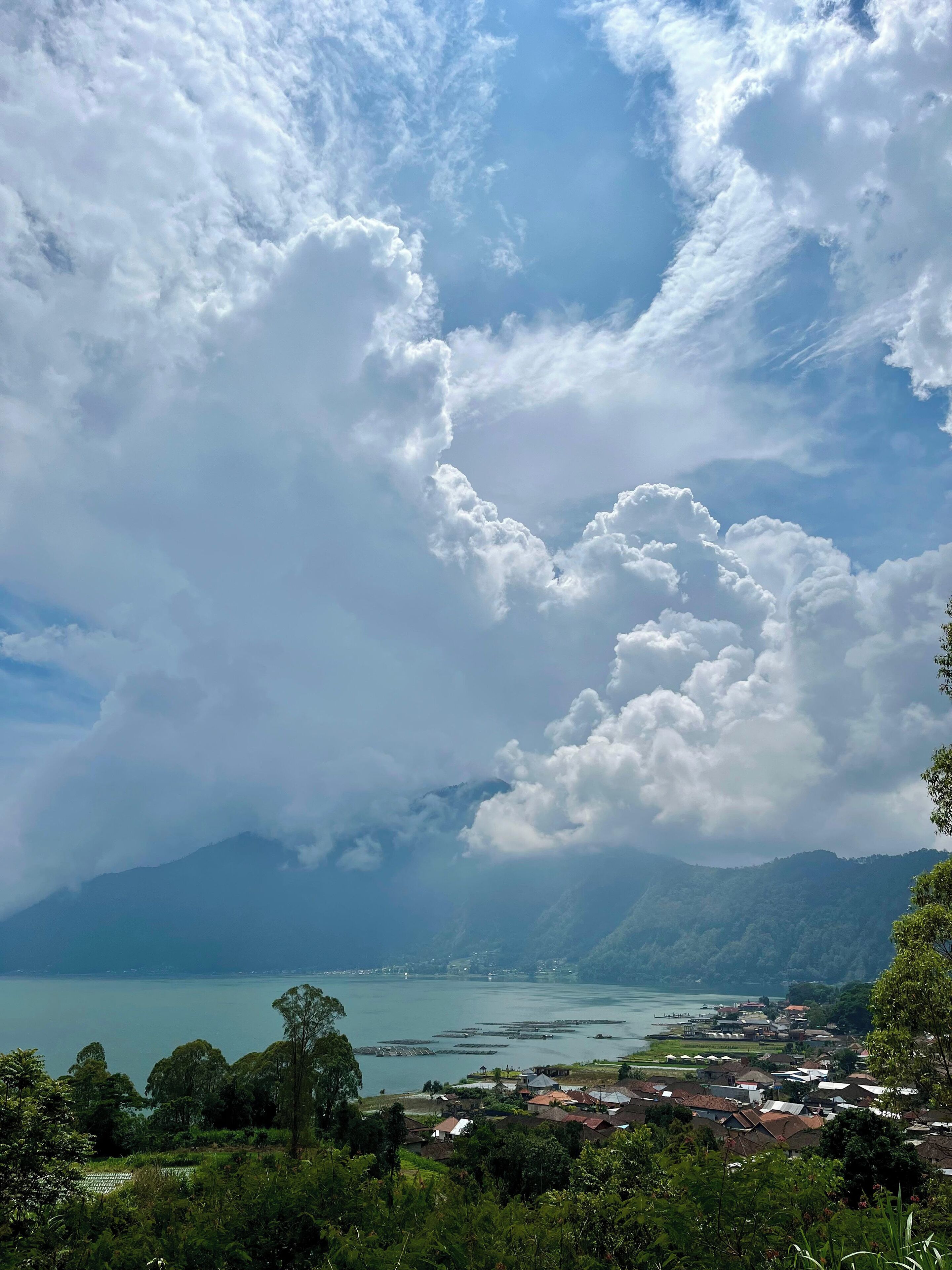 A coastal town with a view of the sea and mountains in the background.