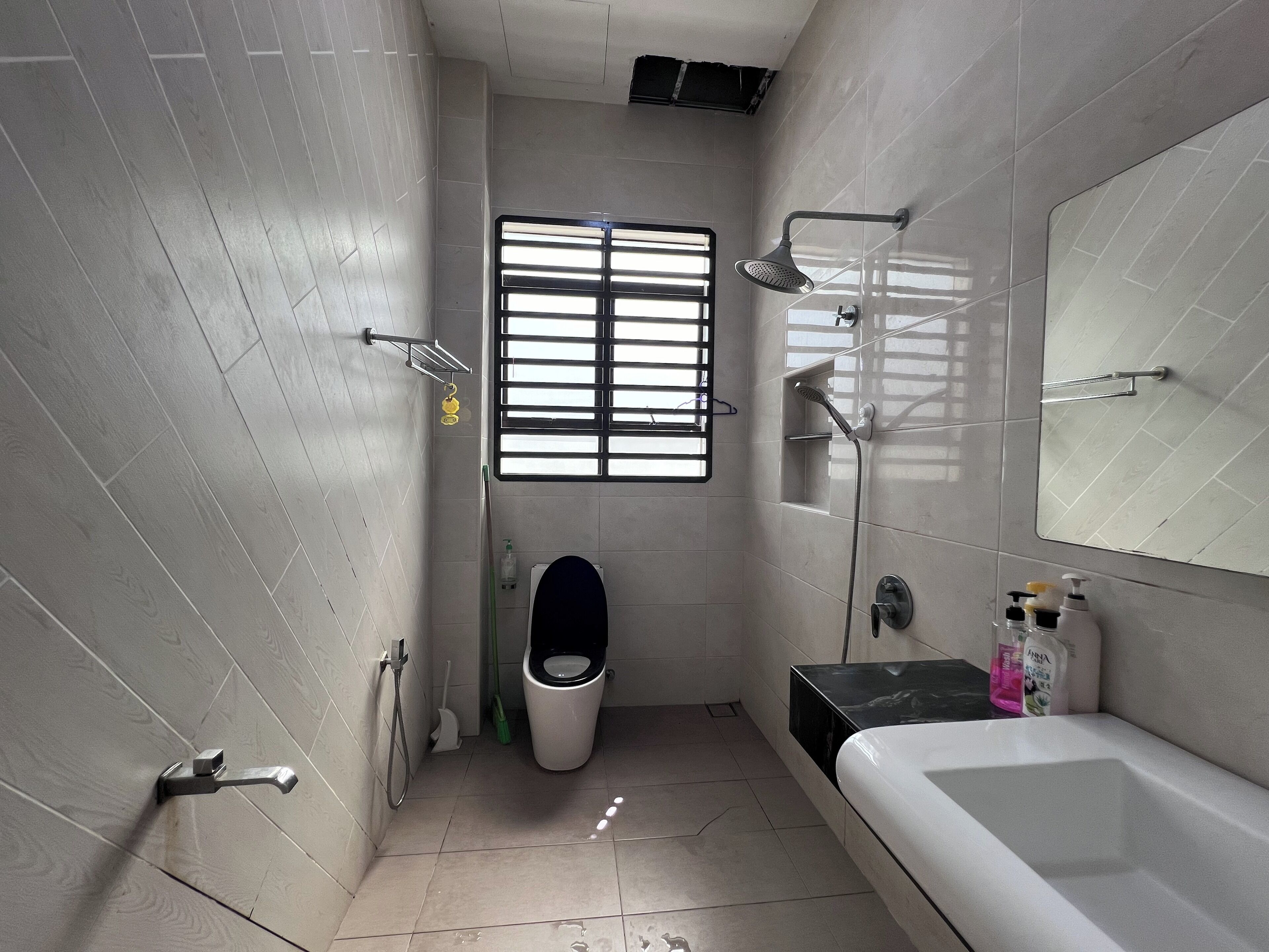 A modern bathroom with a toilet, bidet, shower, and bathtub.