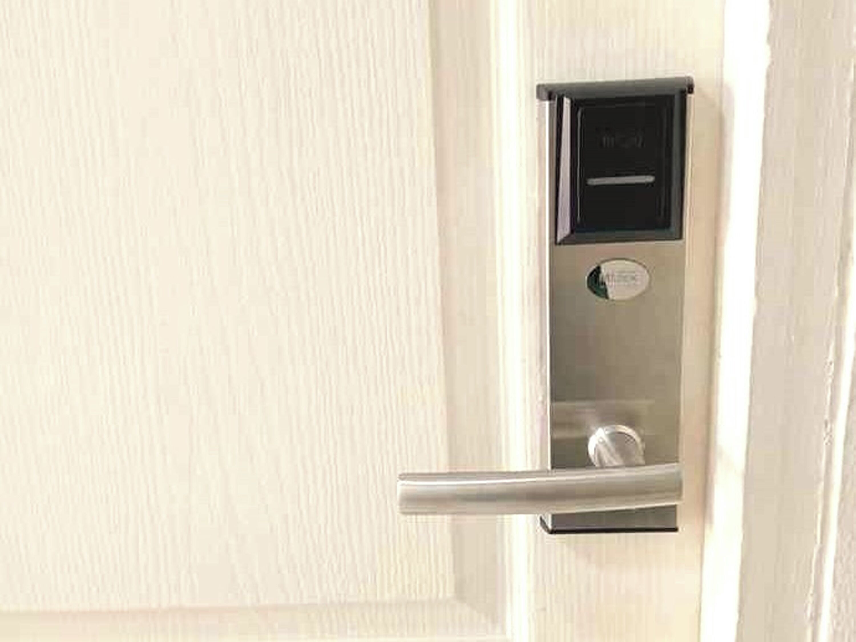 A door with a modern electronic lock and a handle.