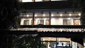 A multi-story building with a balcony and a covered outdoor area. - Aariv Comforts Baga (Baga)