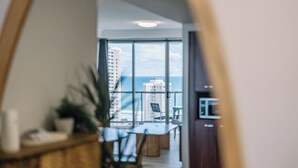 A modern kitchen with a view of the city and the ocean. - Resort Style Chevron Apartments (Surfers Paradise)