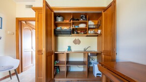 A compact kitchen with wooden cabinetry, a built-in sink, and a countertop. - Ginestre 13 (Is Molas)
