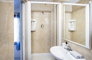 Shower, hair dryer, towels, toilet paper