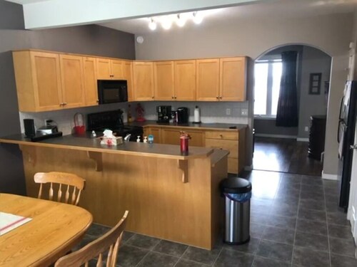 Spacious 4-bedroom townhome in charming Red Deer with WiFi, AC