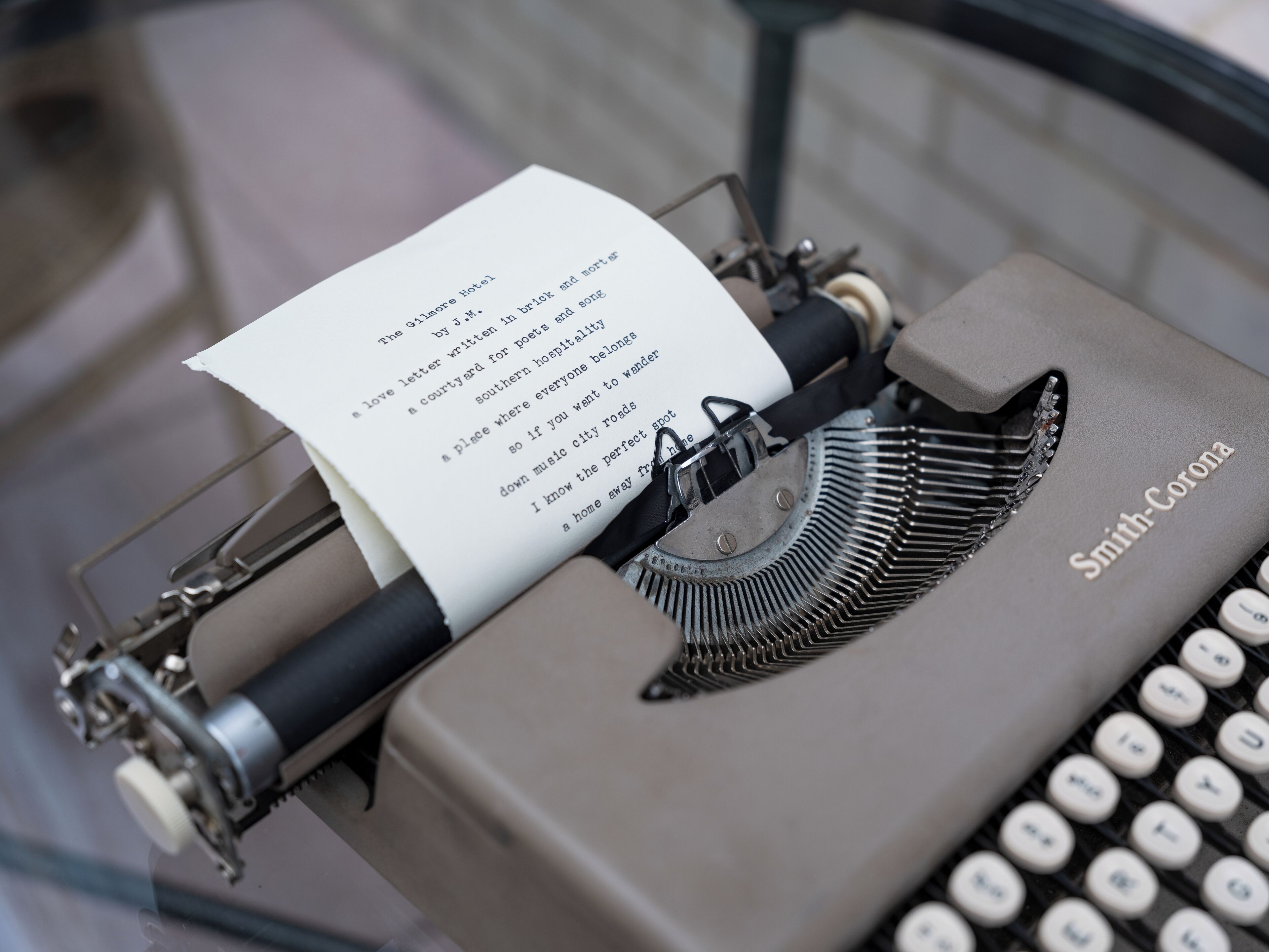 A vintage Smith-Corona typewriter with a sheet of paper inserted.