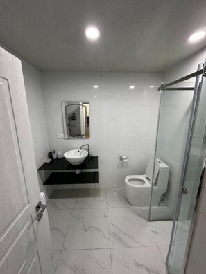 Signature appartement, 1 queensize bed met slaapbank, kitchenette | Badkamer | Een douche, gratis toiletartikelen, handdoeken, zeep